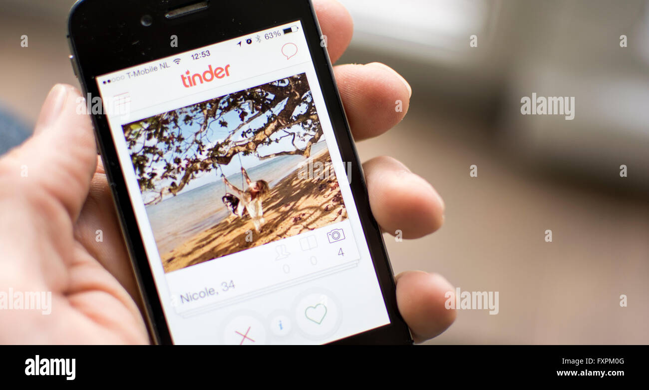 Tinder app on smartphone screen Stock Photo