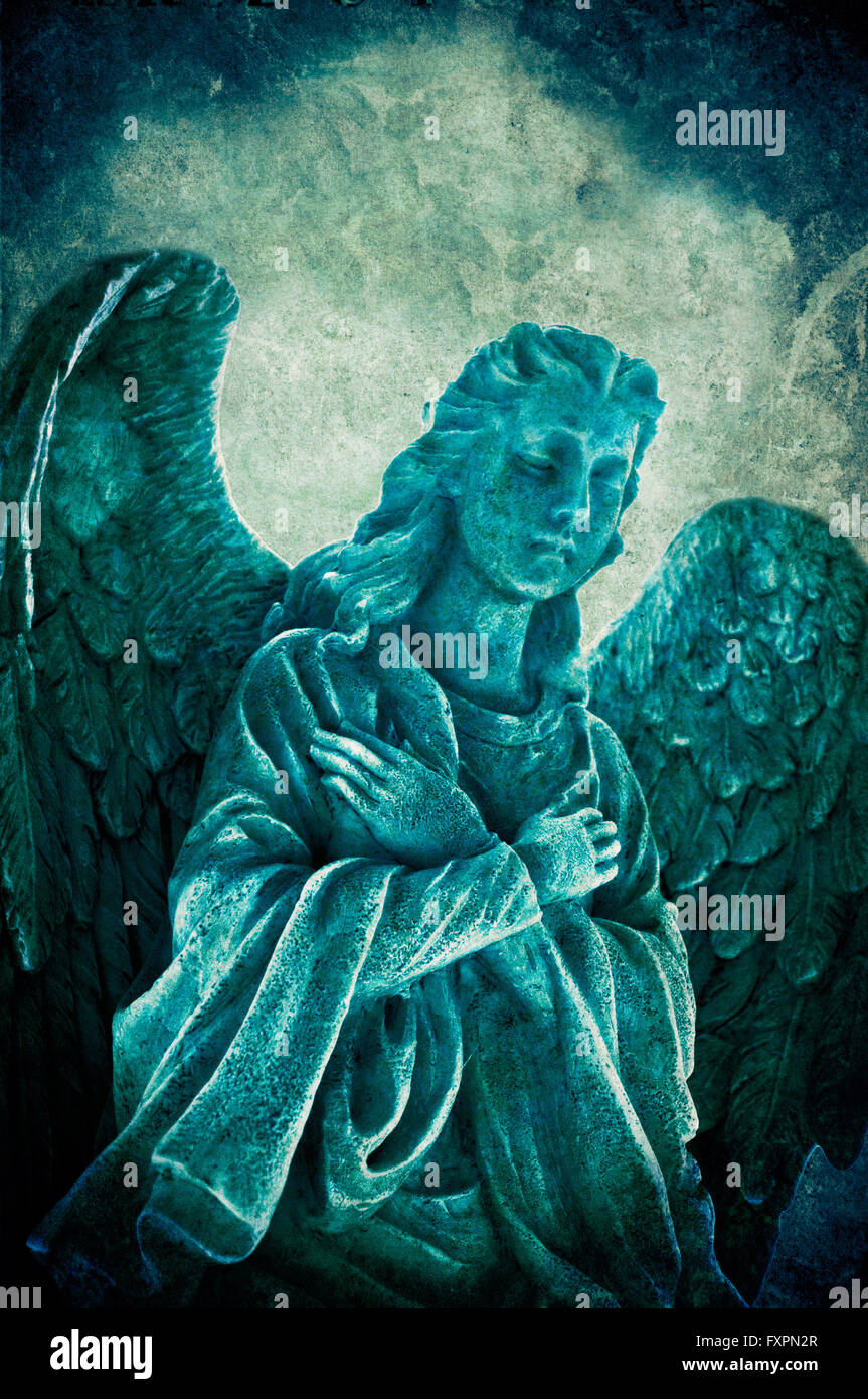 angel statue in prayer, grunge effect Stock Photo Alamy