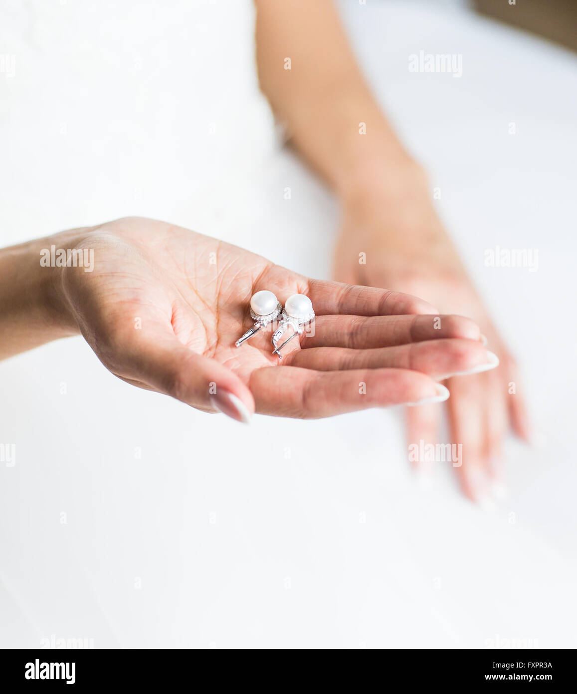 Girl hold earrings with pearl Stock Photo Alamy