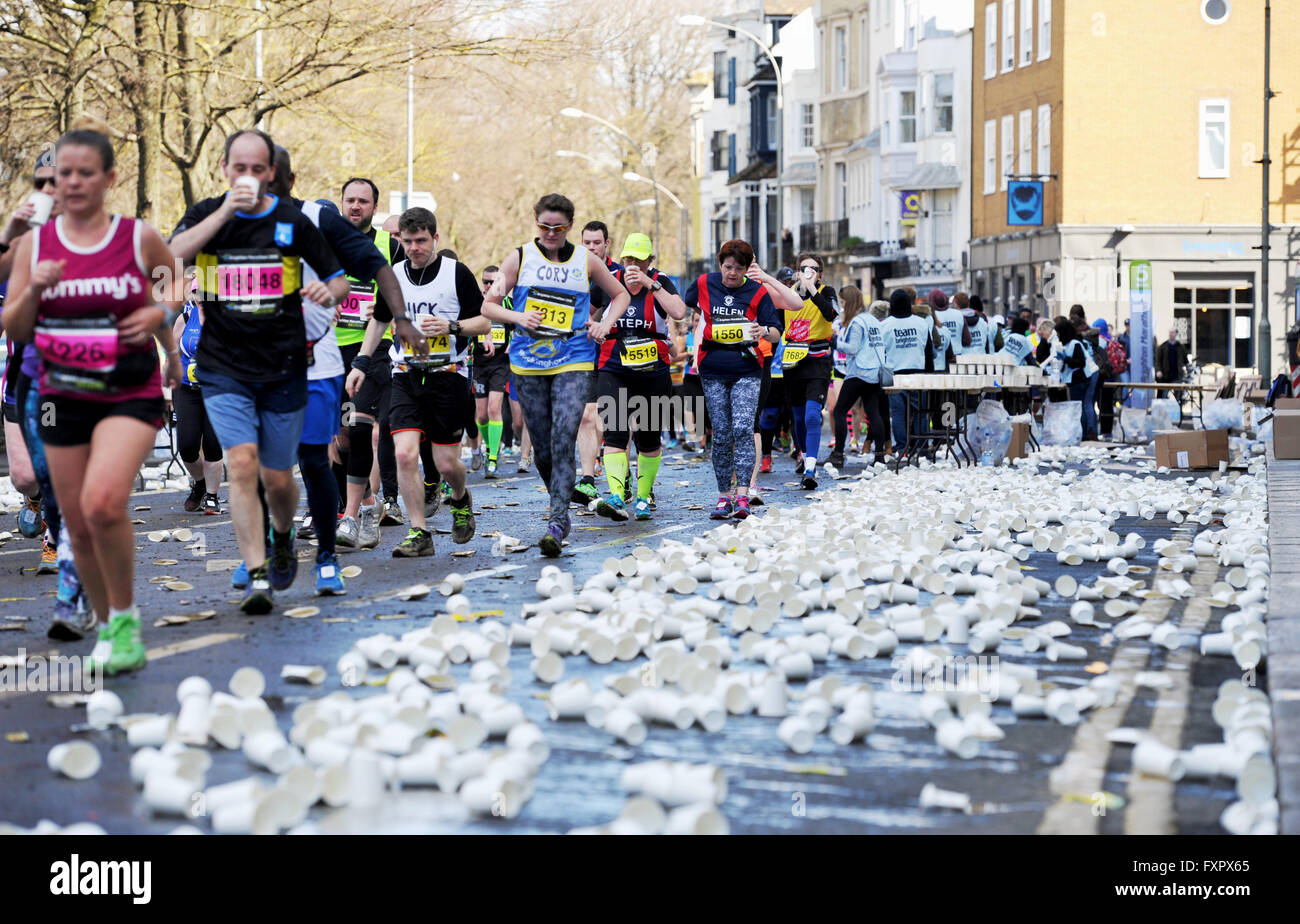 Brighton UK 17th April 2016 Runners grab a drink at a water station