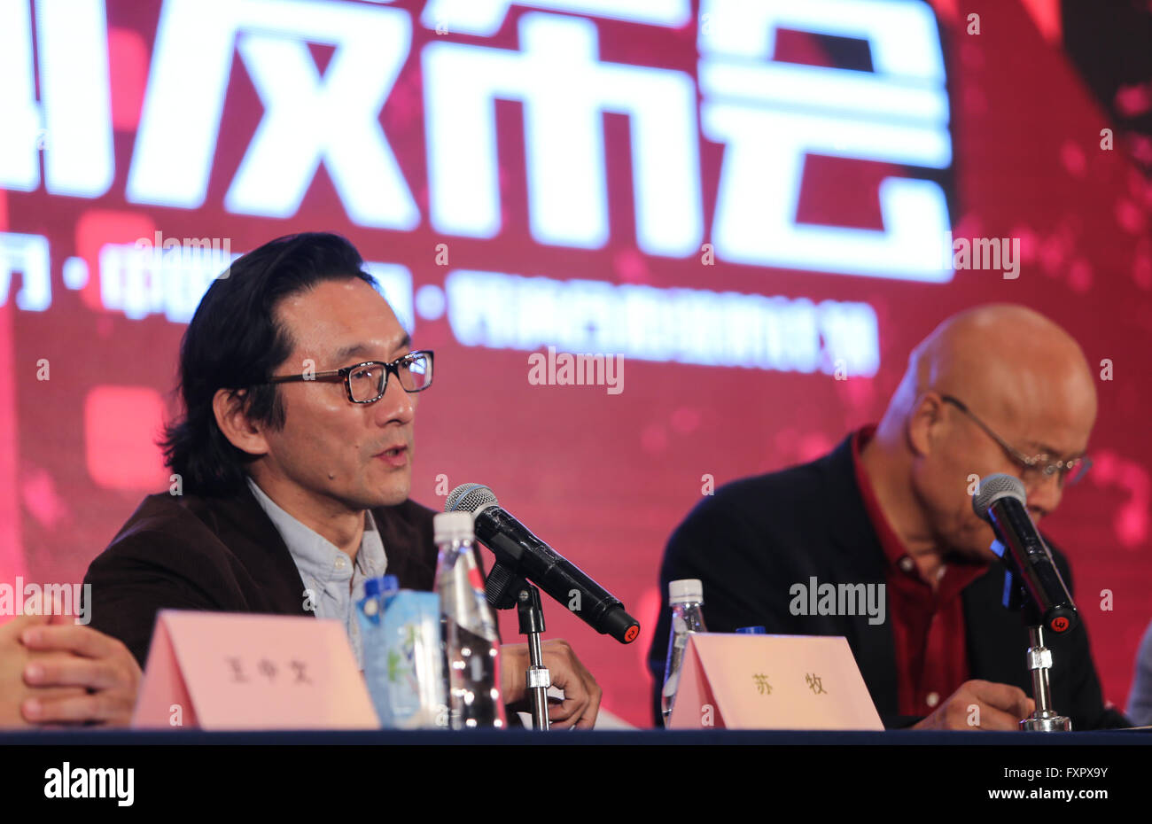 Beijing, China. 17th Apr, 2016. Su Mu (L), a professor of Beijing Film Academy, speaks during a press conference of the first Sino-Spanish film culture exchange project in Beijing, capital of China, April 17, 2016. According to the project, ten Chinese films will be shown during the first Sino-Spanish film week in majors cities of Spain's Andalucia region in November of 2016. Moreover, the Barcelona government will invite Chinese young directors for a one-month shooting project with Spanish directors. © Meng Chenguang/Xinhua/Alamy Live News Stock Photo
