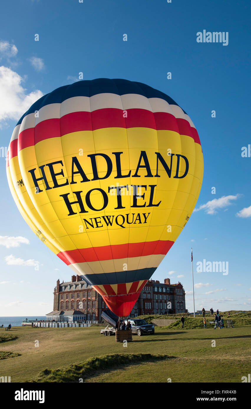 Headland Hotel, Newquay, Cornwall, 17th April 2016.   A colourful hot air balloon prepares to take to the sky above the Headland Hotel in Newquay, Cornwall.  Photographer;  Gordon Scammell/Alamy Live News Stock Photo