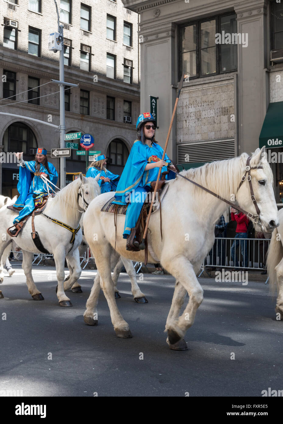 Women in traditional Iranian / Persian costume ride white horses in the ...