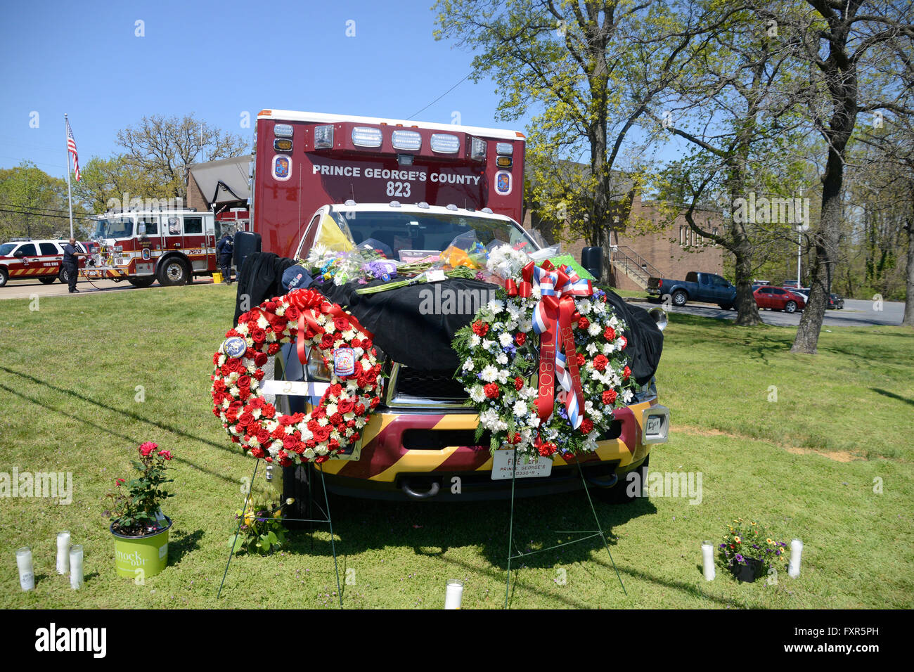 Prince Georges County , Maryland  USA  April 14.2016 An ambulances is covered with flowers and candles in memory after 2 firefighters were shot killing a 13 year veteran firefighter with Prince George's County Fire Department and severely injuring a 19 yr old volenteer firefighter from Morningside Vol Fire Department after they wre checking on a man who had diabetic problems ,The broke in when he didn't answer the door so they forced their way in and he thought they were intruders and opened fire on them Stock Photo