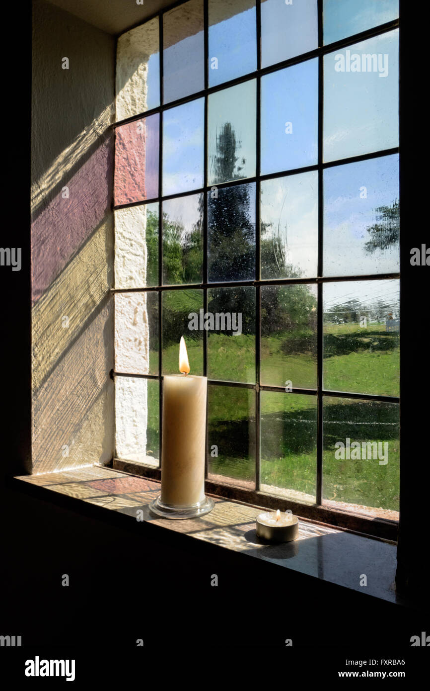 Burning candles in a window Stock Photo Alamy