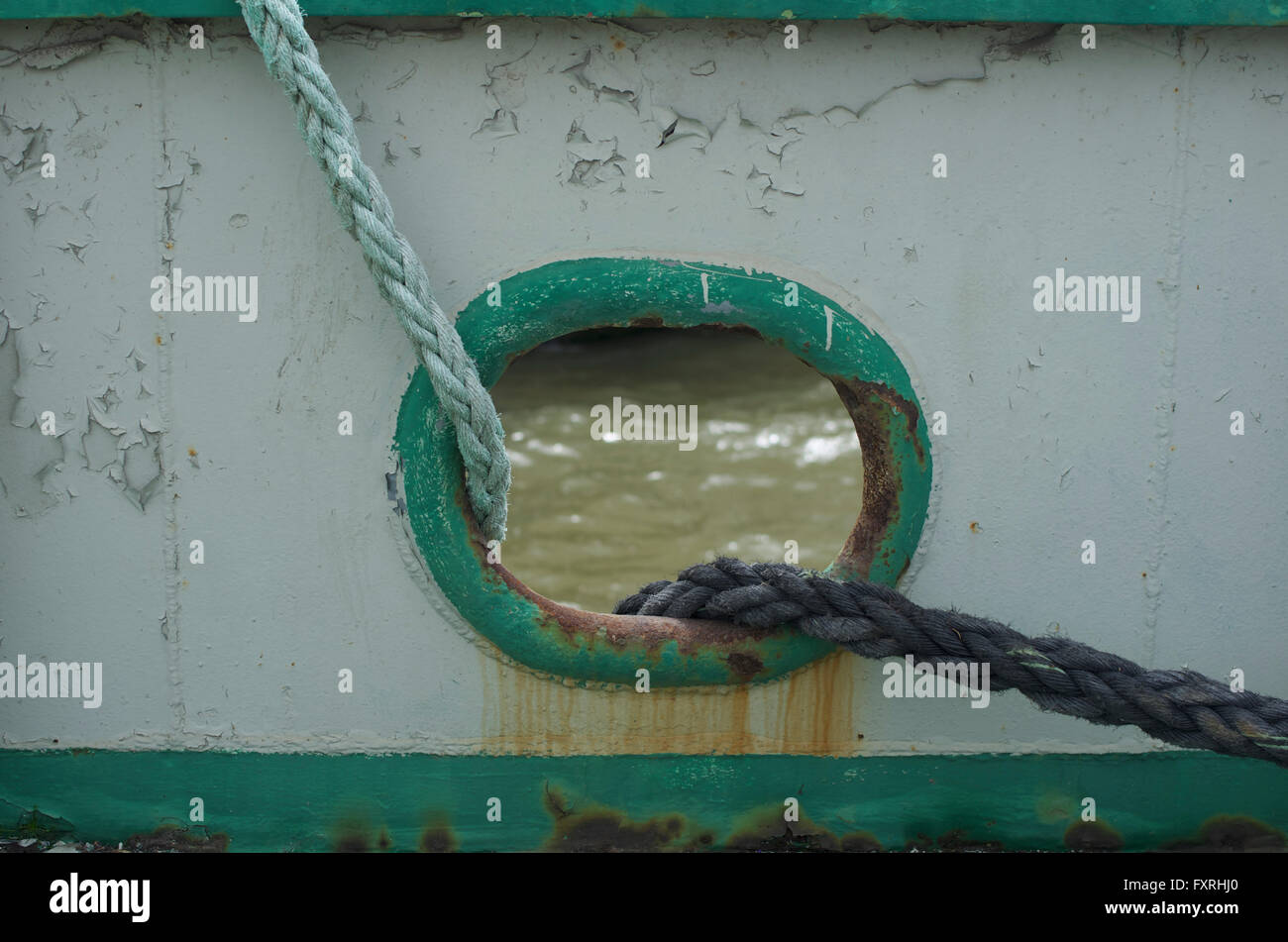 Ropes passing through a ship's porthole, Setubal, Portugal Stock Photo