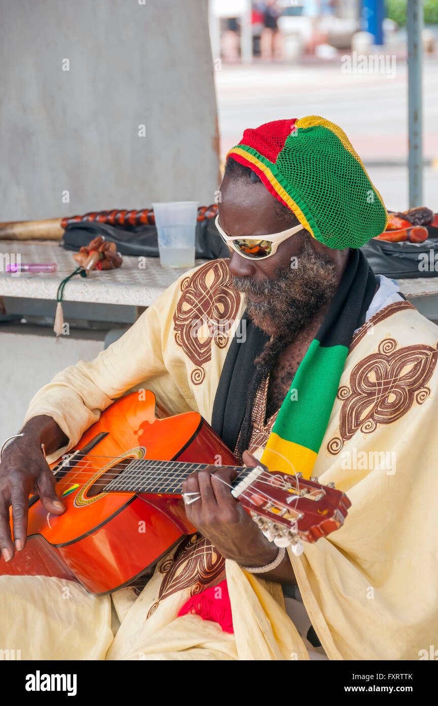 Man colorfully dressed plays guitar Willemstad Curacao Stock Photo