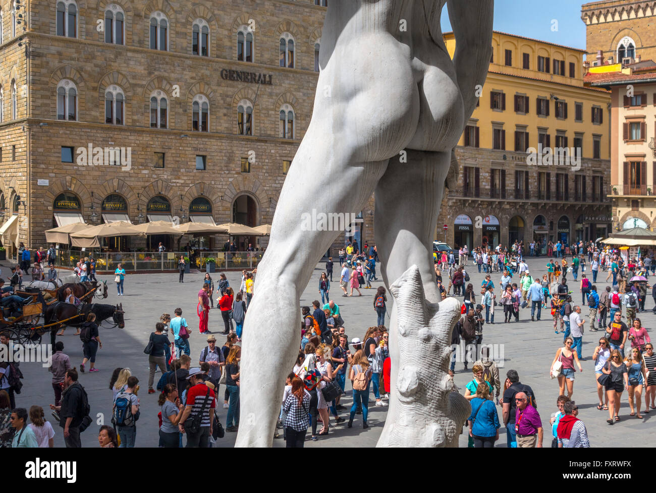 Florence Italy. David by Michelangelo in the Piazza della Signoria Square Florence with tourists. Statue of  David seen from behind. Stock Photo