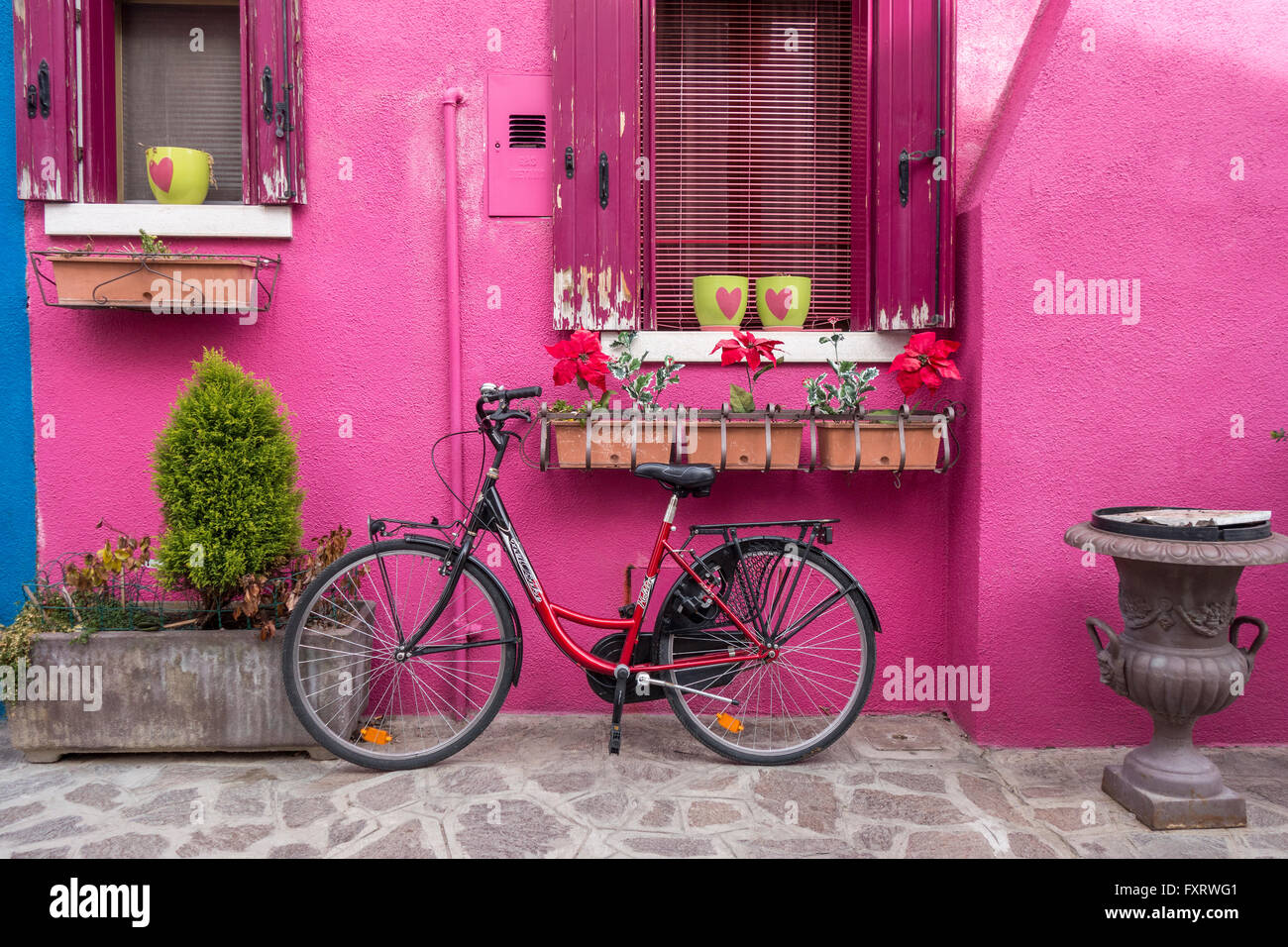 Venice - Island of Burano colorful colourful pink house with a bicycle Stock Photo