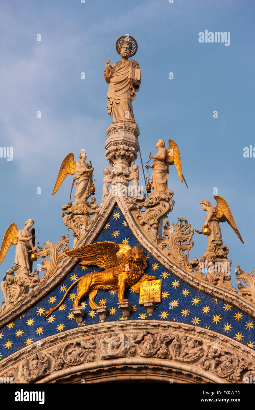 San Marco Cathedral, Venice, detail of the facade. St Mark with angels above the Winged Lion, symbol of Venice and the saint. Stock Photo