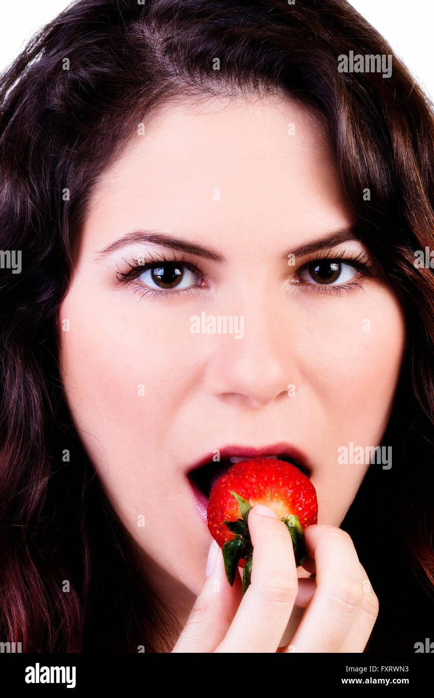 Young Caucasian Woman Putting Strawberry In Mouth Stock Photo