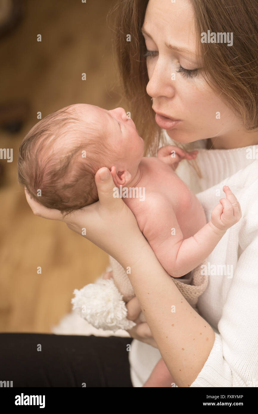 Infant boy on the mother hands Stock Photo