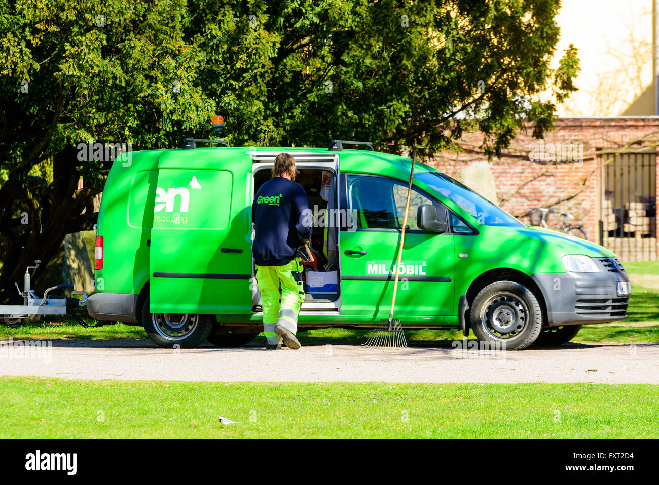 Lund, Sweden - April 11, 2016: Everyday life in the city. Green landscaping is out with their green eco car doing a job in town. Stock Photo