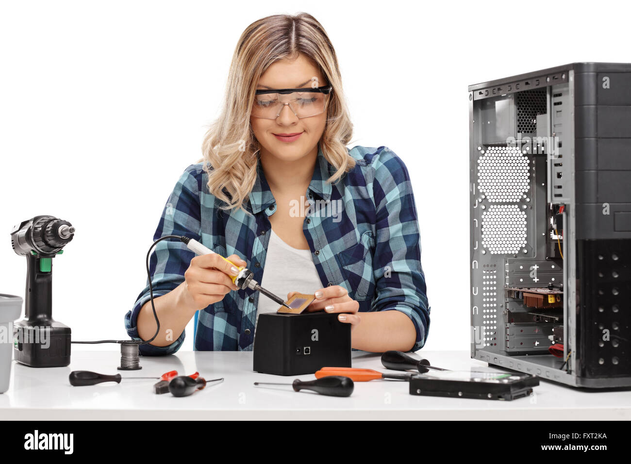 Female PC technician soldering a chip from a desktop computer isolated on white background Stock Photo