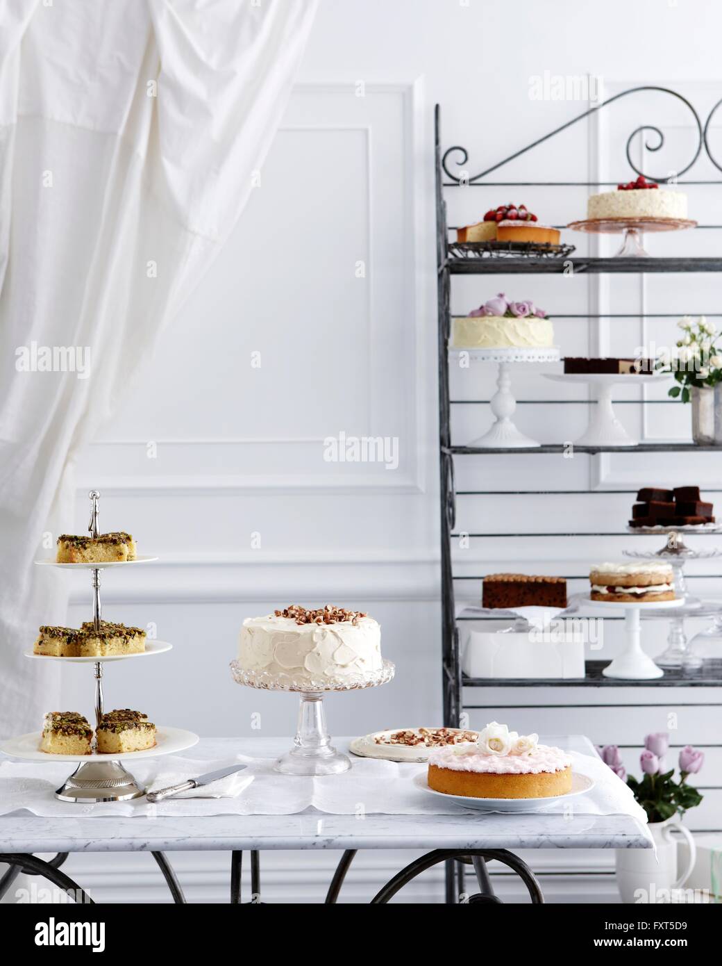 Selection of cakes on traditional tea table and stand Stock Photo