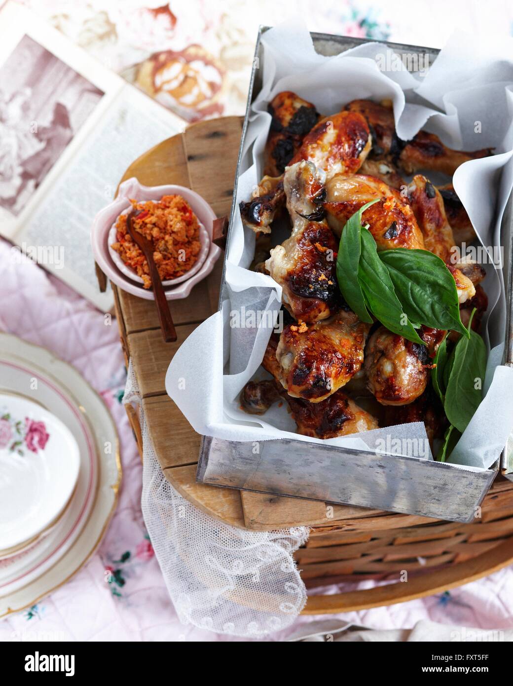 High angle view of chicken legs with citrus chilli salt and basil Stock Photo