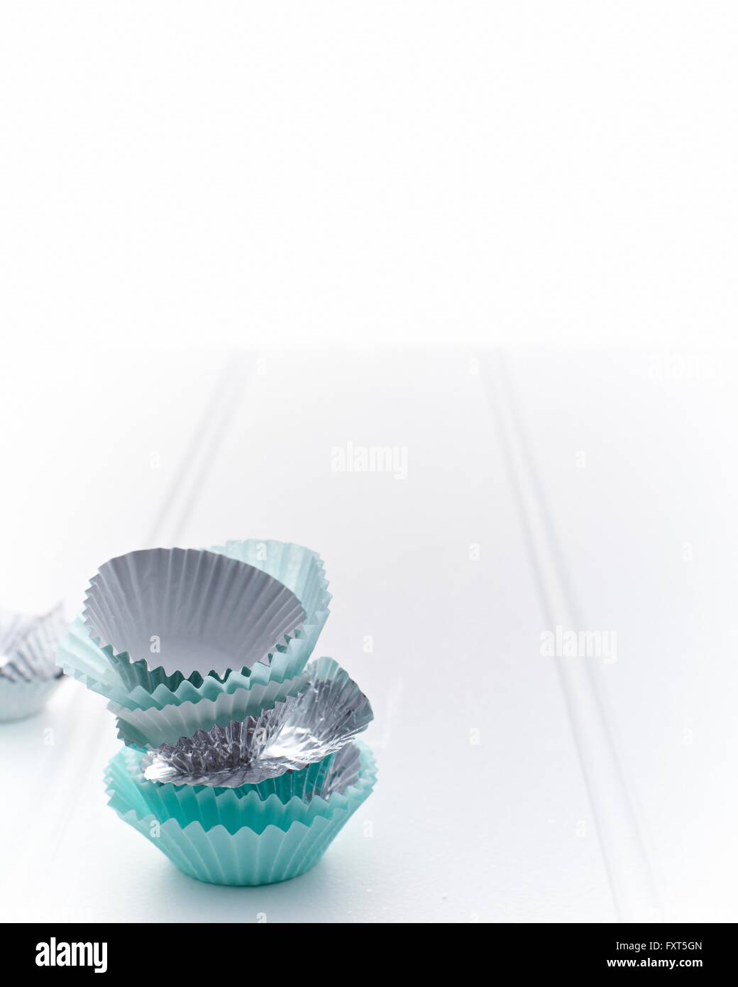 Stack of turquoise and silver cupcake cases Stock Photo