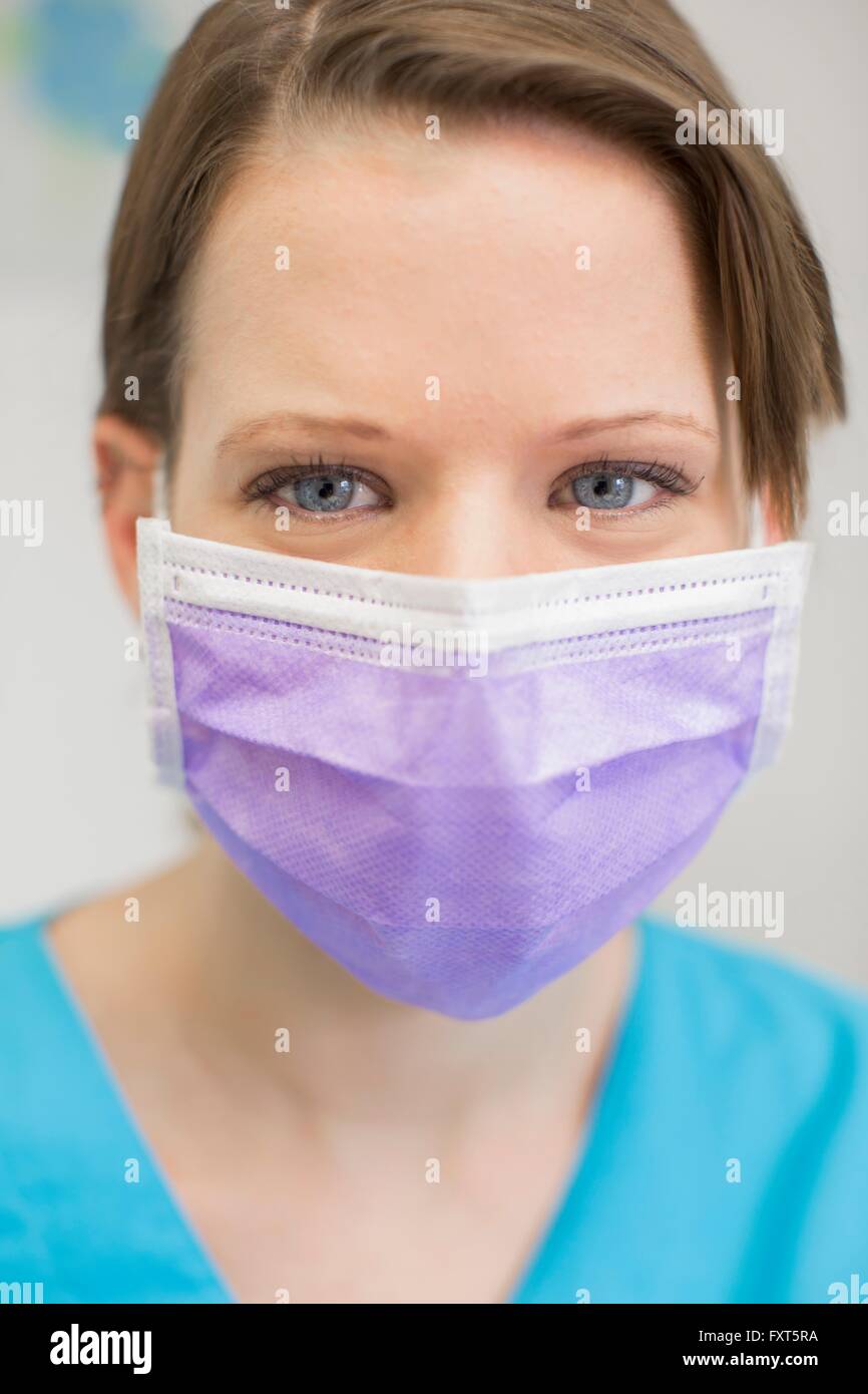 Portrait of young female dentist wearing mask looking at camera Stock Photo