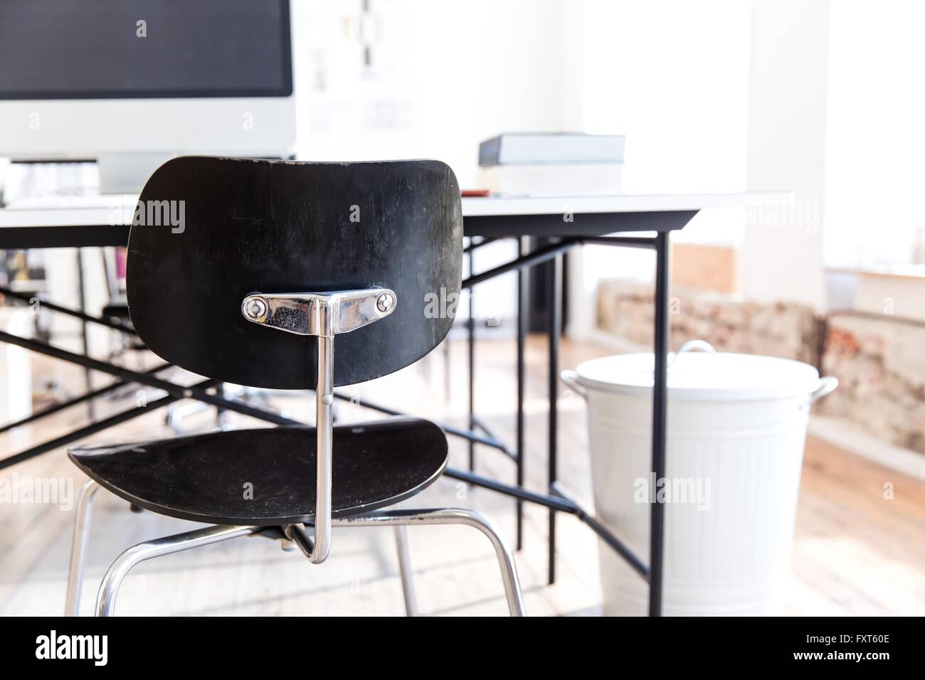 Desk and chairs and rubbish bin in office Stock Photo Alamy