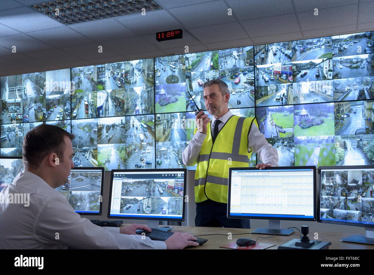 Security Guards In Security Control Room With Video Wall