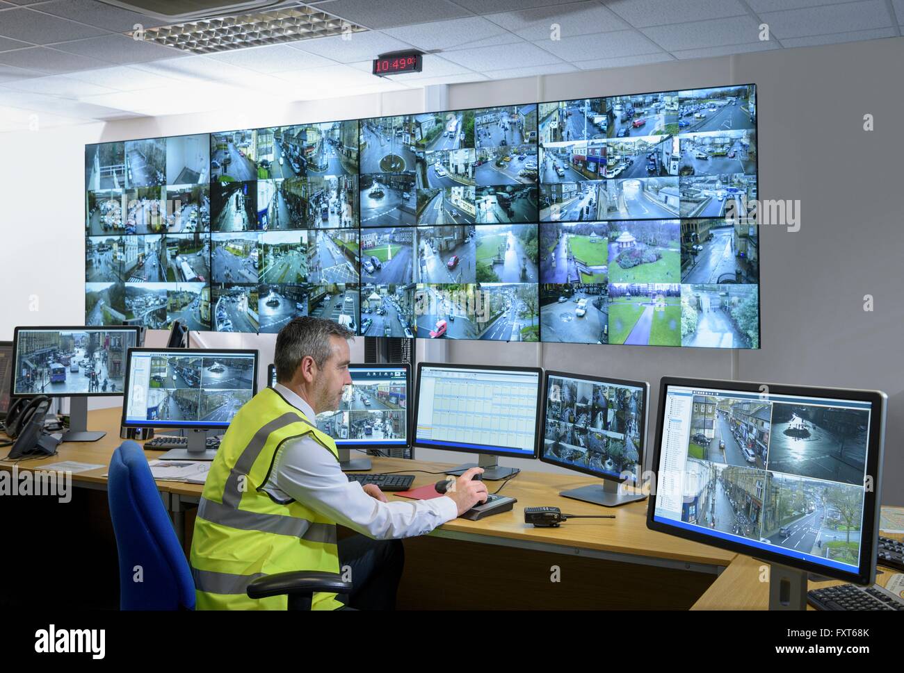 Security guard in security control room with video wall Stock Photo