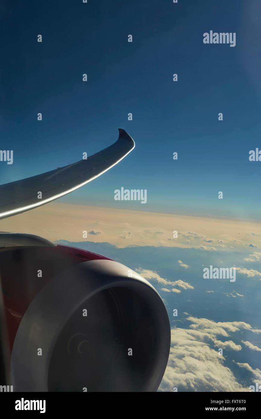 View through airplane window of wing and engine Stock Photo