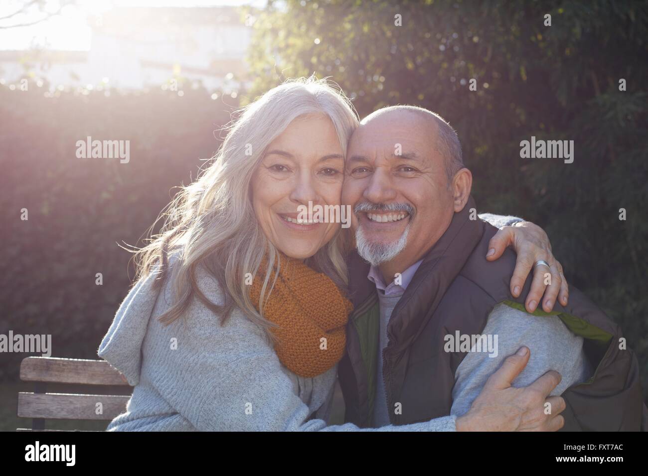 Mature couple hugging, looking at camera smiling Stock Photo