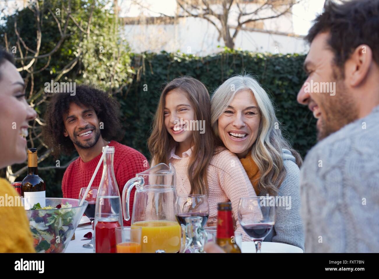 Multi generation family dining outdoors, smiling Stock Photo