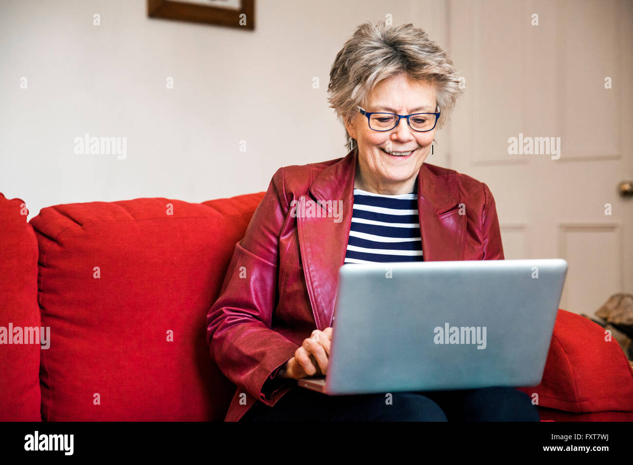 Woman on leather sofa hi-res stock photography and images - Alamy