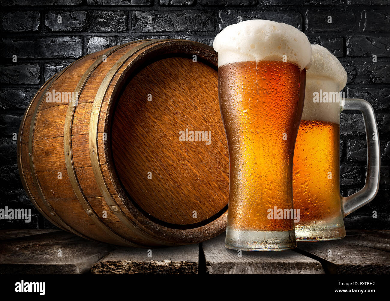 Beer and wooden keg near black brick wall Stock Photo