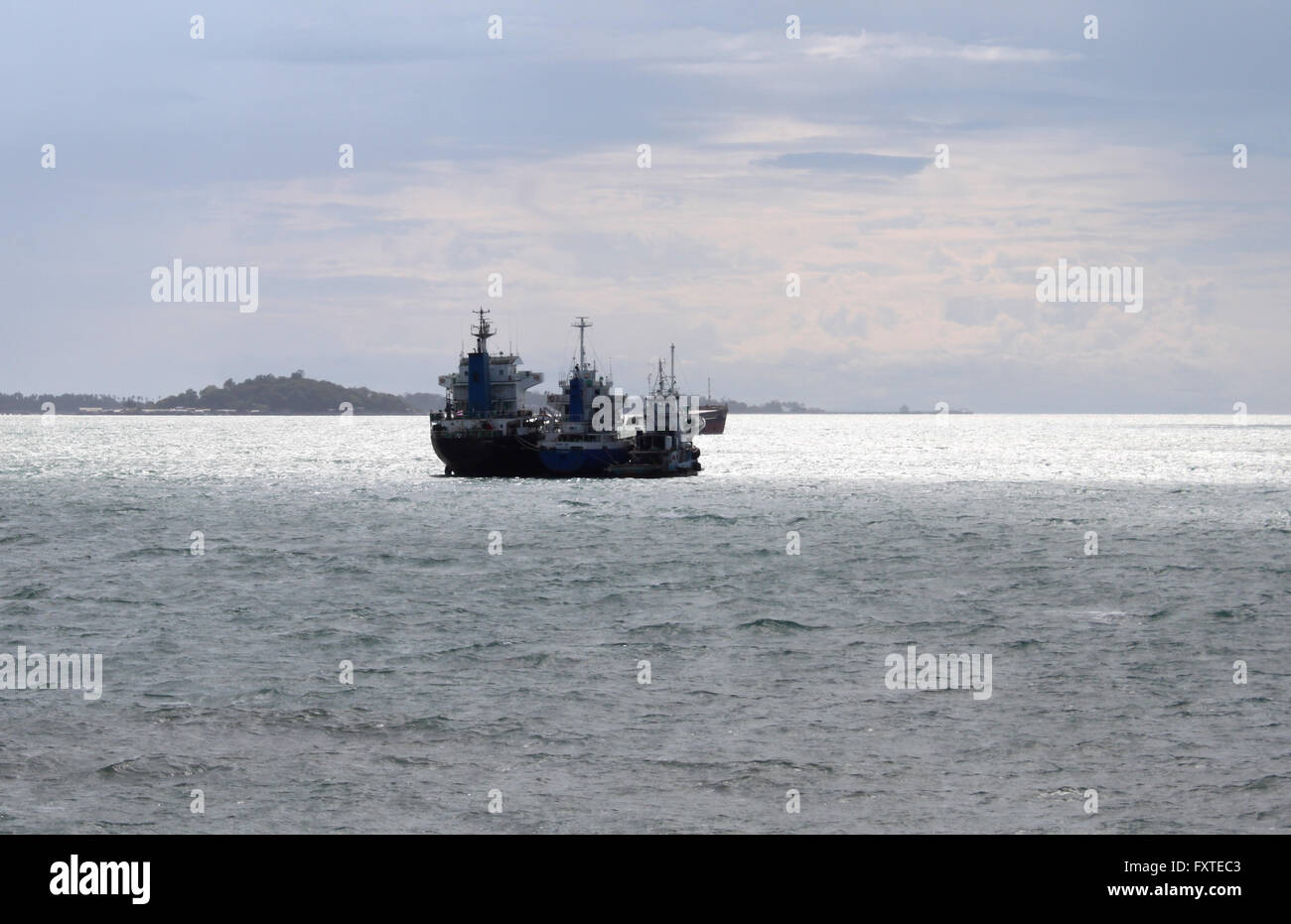 Seascape with three ships moored together in the ocean Stock Photo