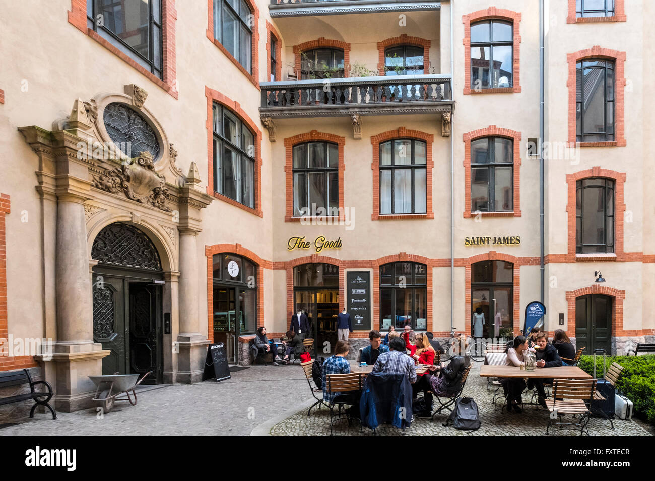 Blue Yard courtyard containing cafes and fashion boutiques and shops in Mitte Berlin Germany Stock Photo