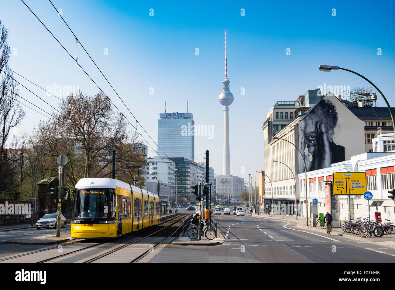 "JR" mural on building wall and Television Tower in Berlin Germany Stock Photo