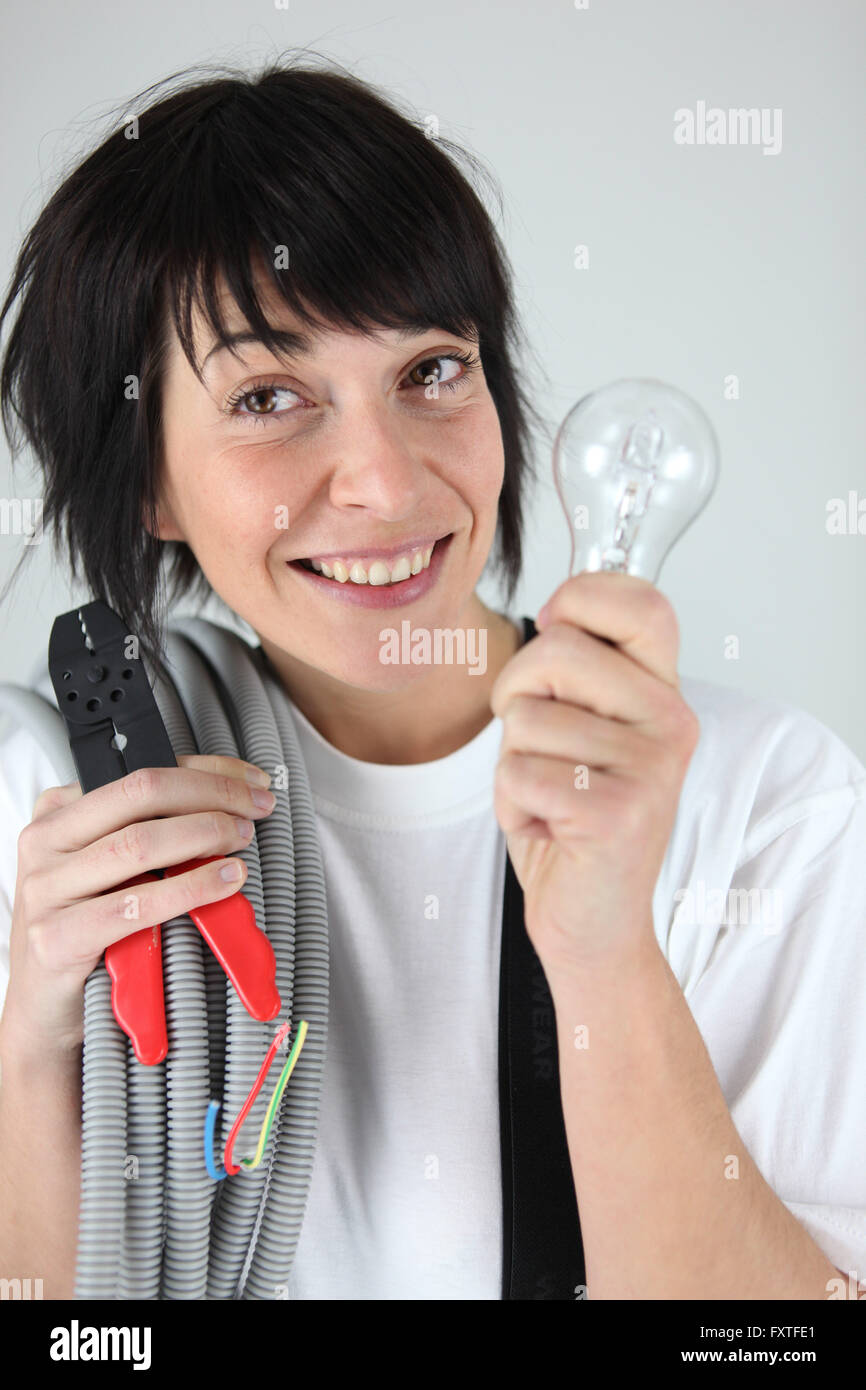 Female electrician holding replacement wiring and bulb Stock Photo Alamy