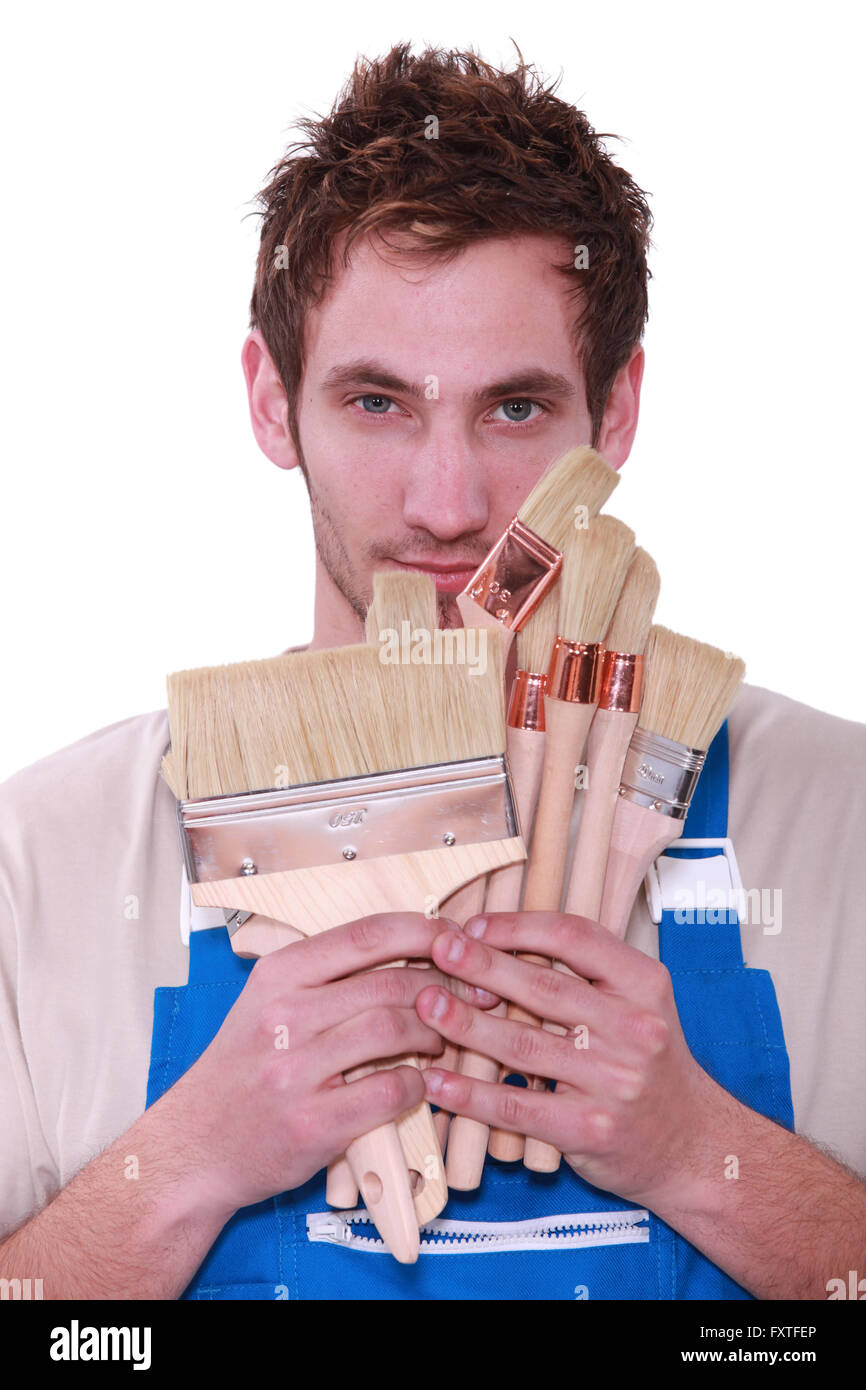 Decorator holding selection of paint brushes Stock Photo Alamy