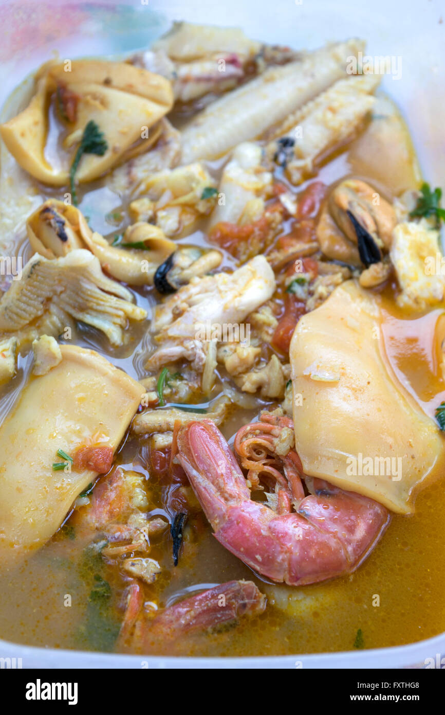 sea soup of fresh mixed fish: mollusks prawns mussels and clams Stock Photo