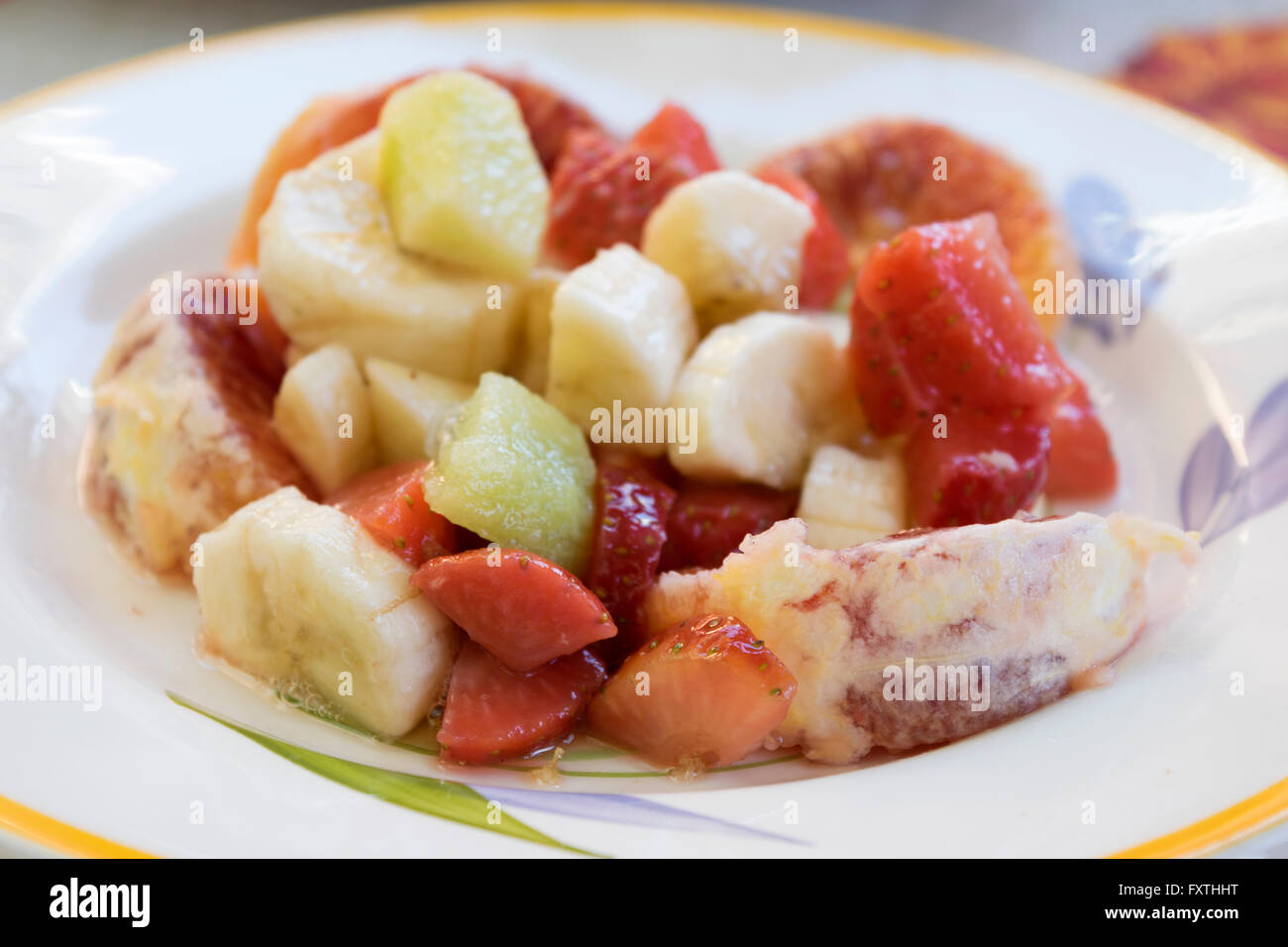 macedoine of fresh and colored fruit with strawberries oranges apples and bananas Stock Photo