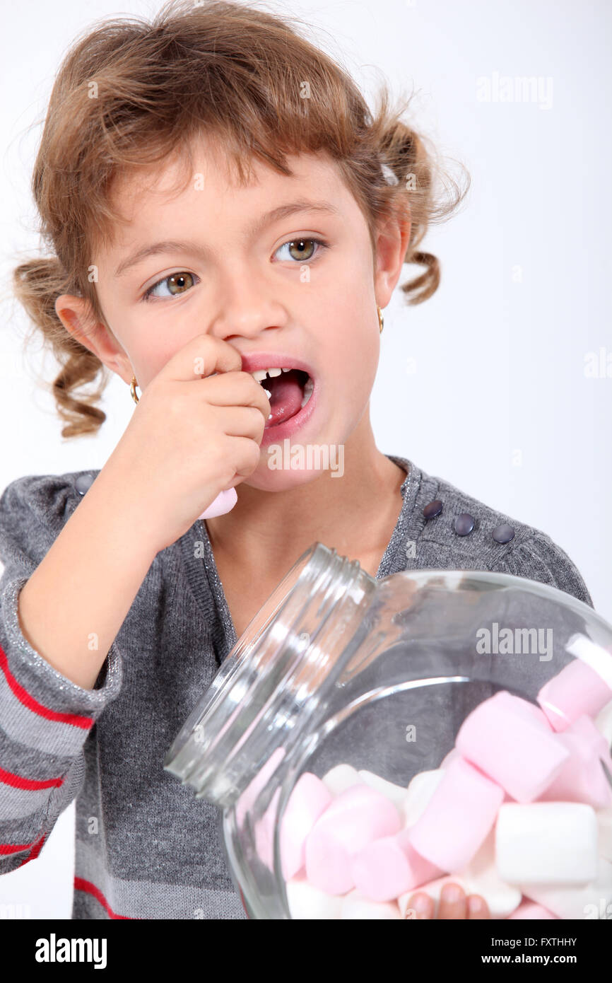 Little girl eating marshmallows Stock Photo Alamy