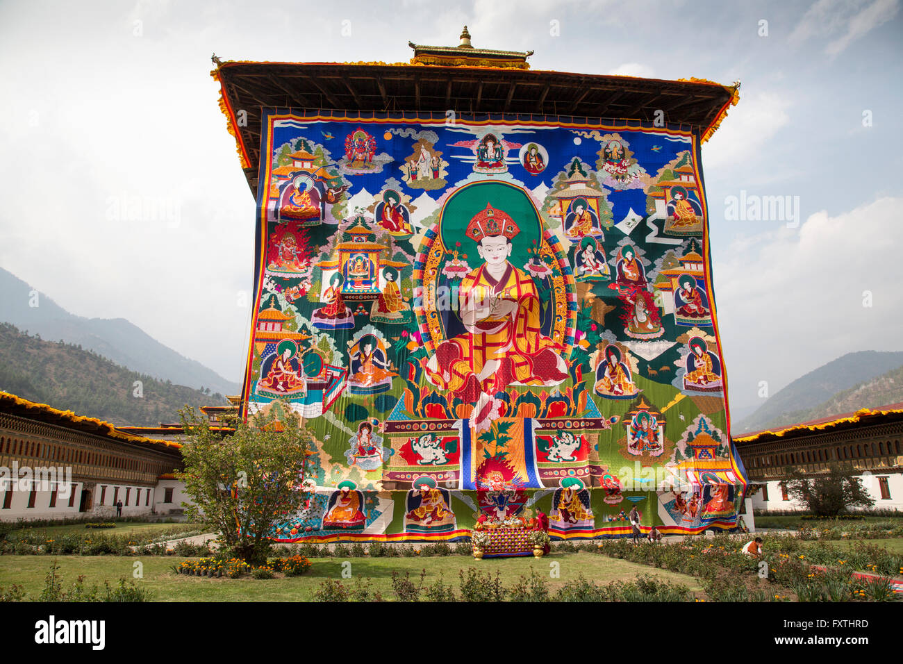 A giant tapestry depicting the history of Bhutan at Tashichhoedzong, a Buddhist monastery and fortress in the Capitol, Thimpu. Stock Photo
