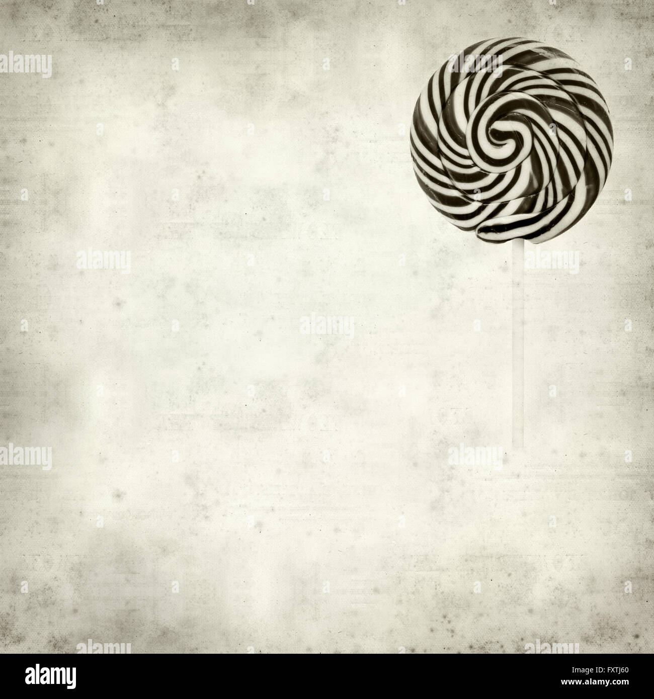 textured old paper background with large black and white swirl lolipop ...