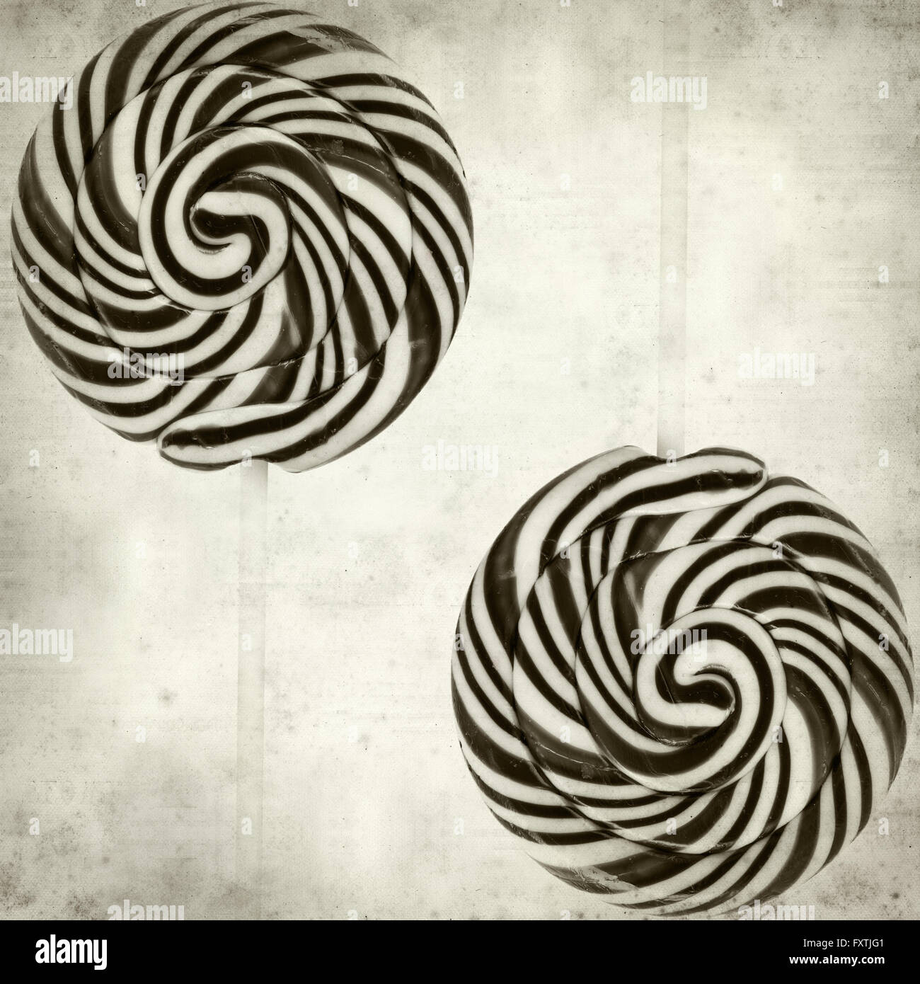 textured old paper background with large black and white swirl lolipop ...