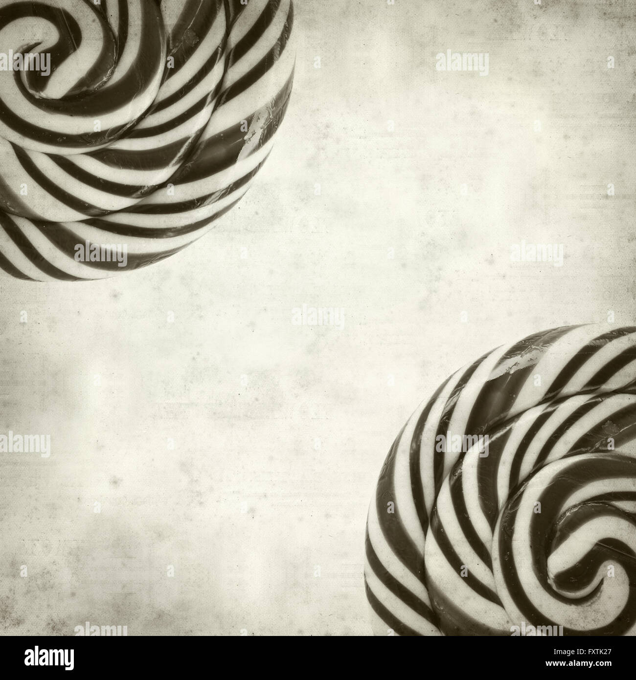textured old paper background with large black and white swirl lolipop