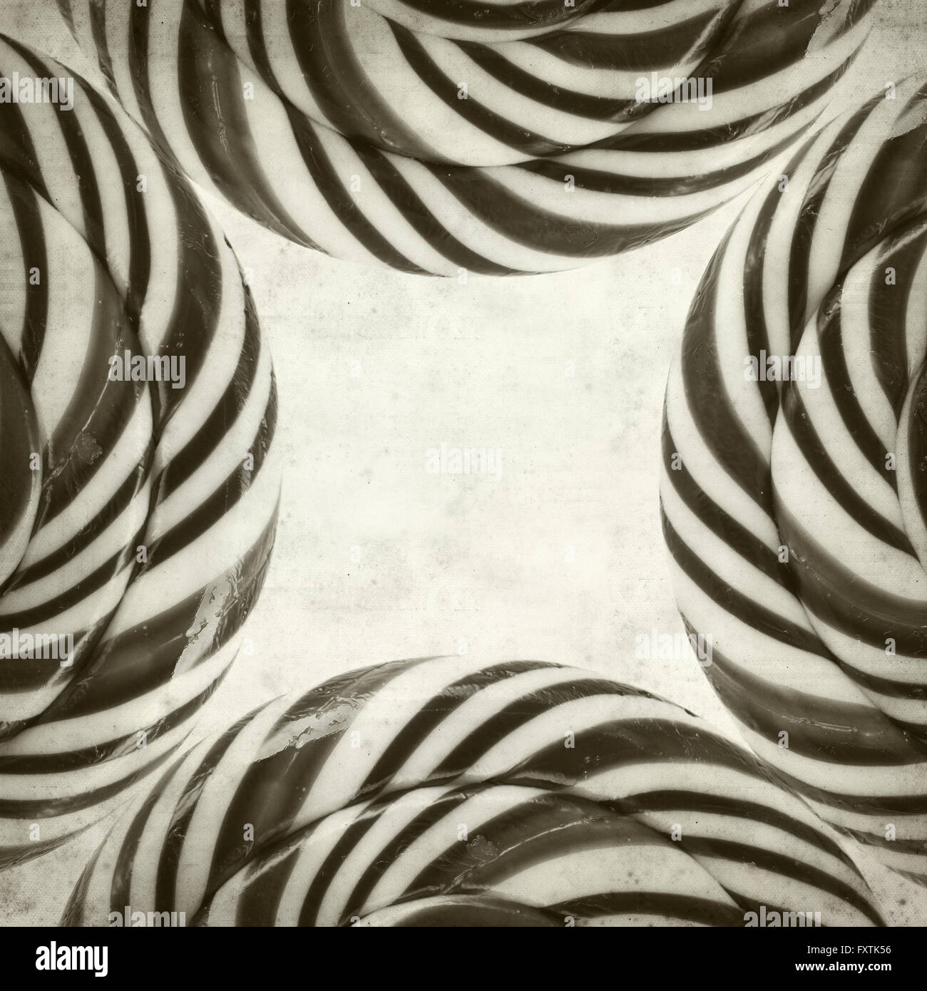 textured old paper background with large black and white swirl lolipop ...