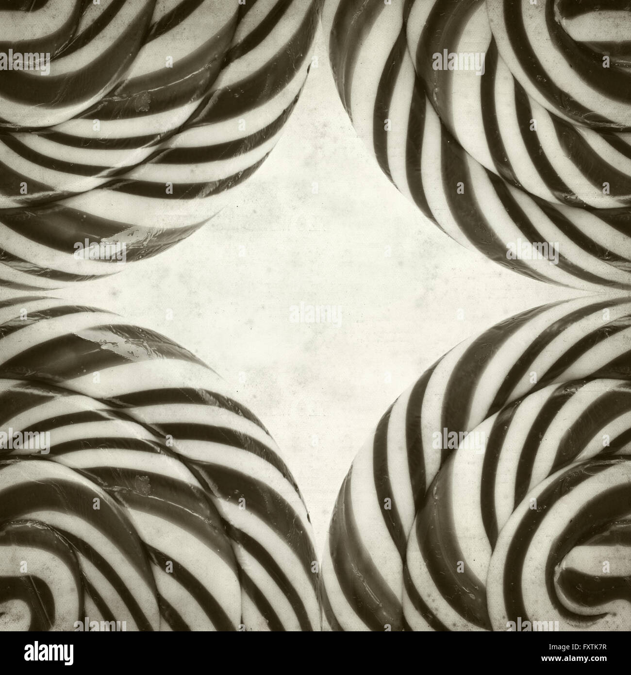 textured old paper background with large black and white swirl lolipop ...