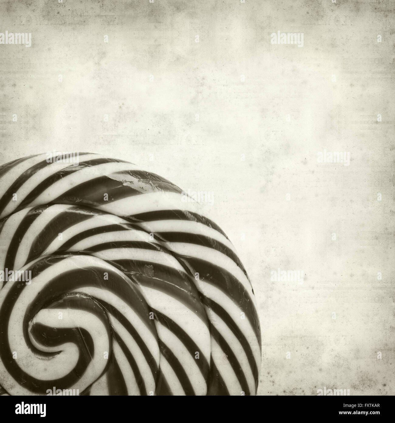 textured old paper background with large black and white swirl lolipop ...