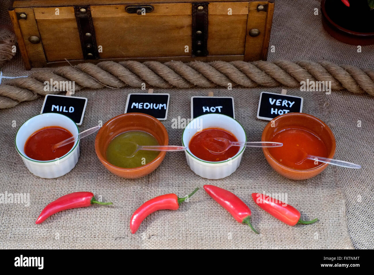chilli sauces of various strengths for sale at a street market in southsea england uk Stock Photo