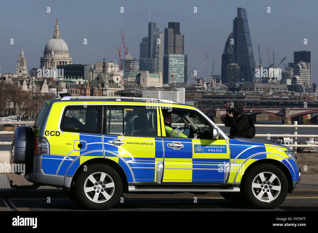 Metropolitan Police patrol over London Bridge with the City of London in the background in London on 13 March, 2016. Stock Photo