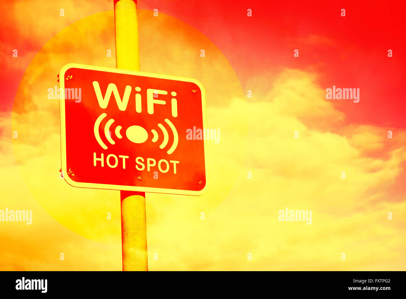 Wifi hotspot sign against a hot red and yellow background Stock Photo