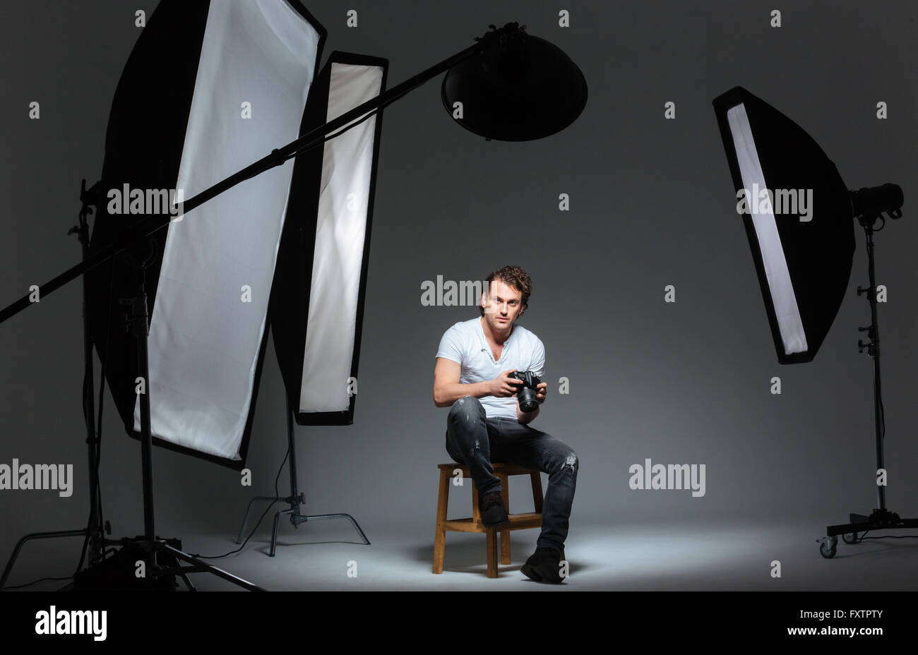 Young man sitting on box, studio hi-res stock photography and images ...