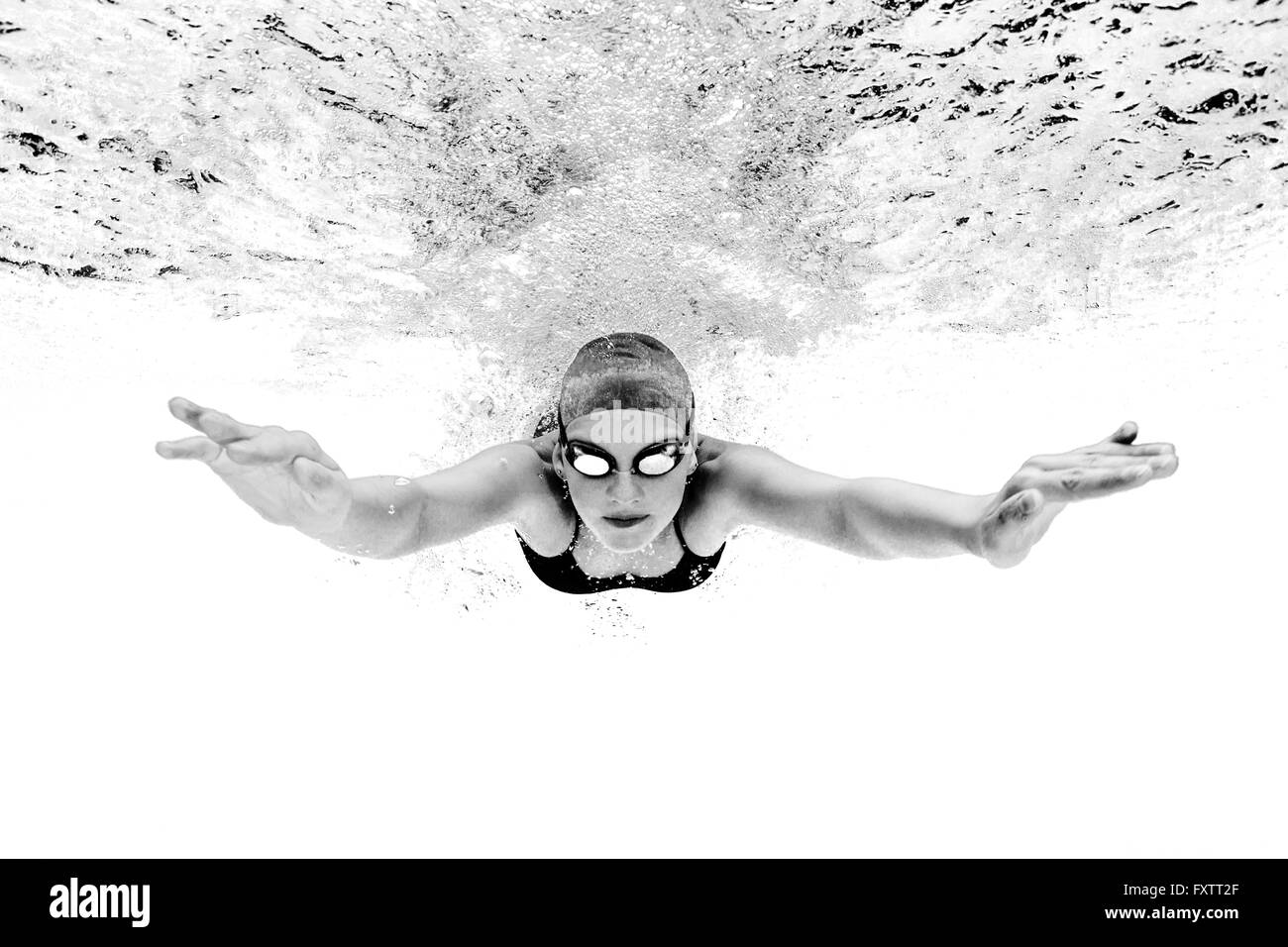 Young woman swimming underwater Stock Photo